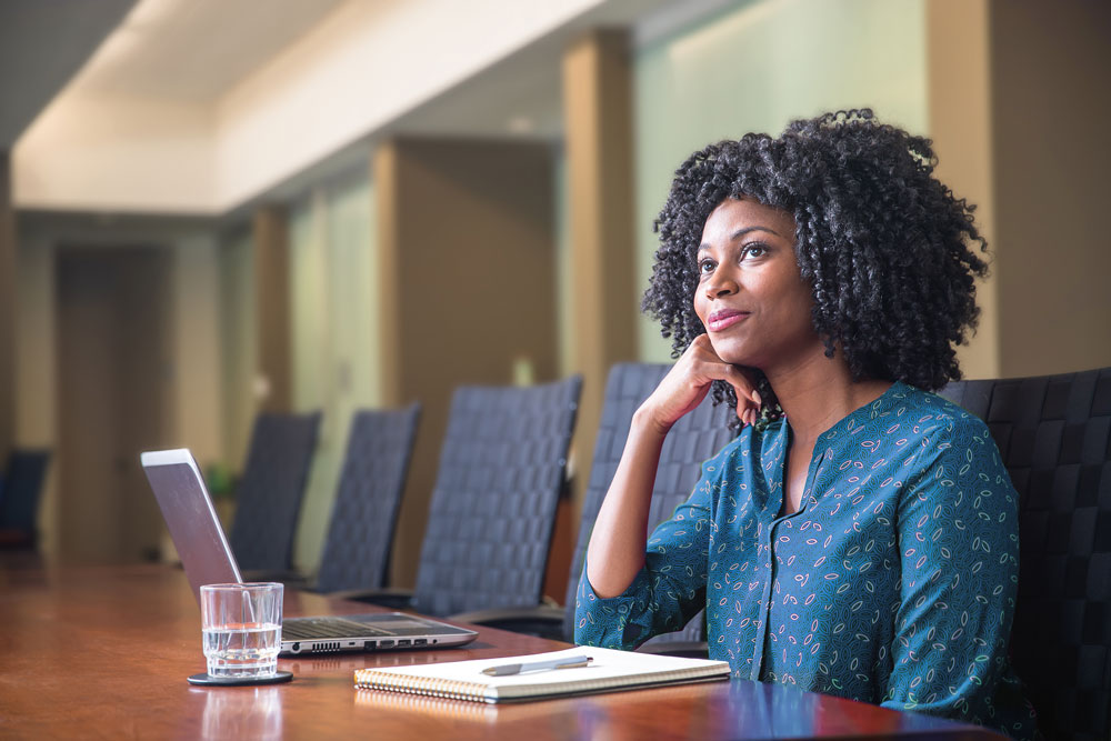 Millennial woman at a conference table